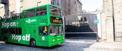 The famous Guinness Gates with a green DoDUblin Bus Dodublin bus at guinness gates