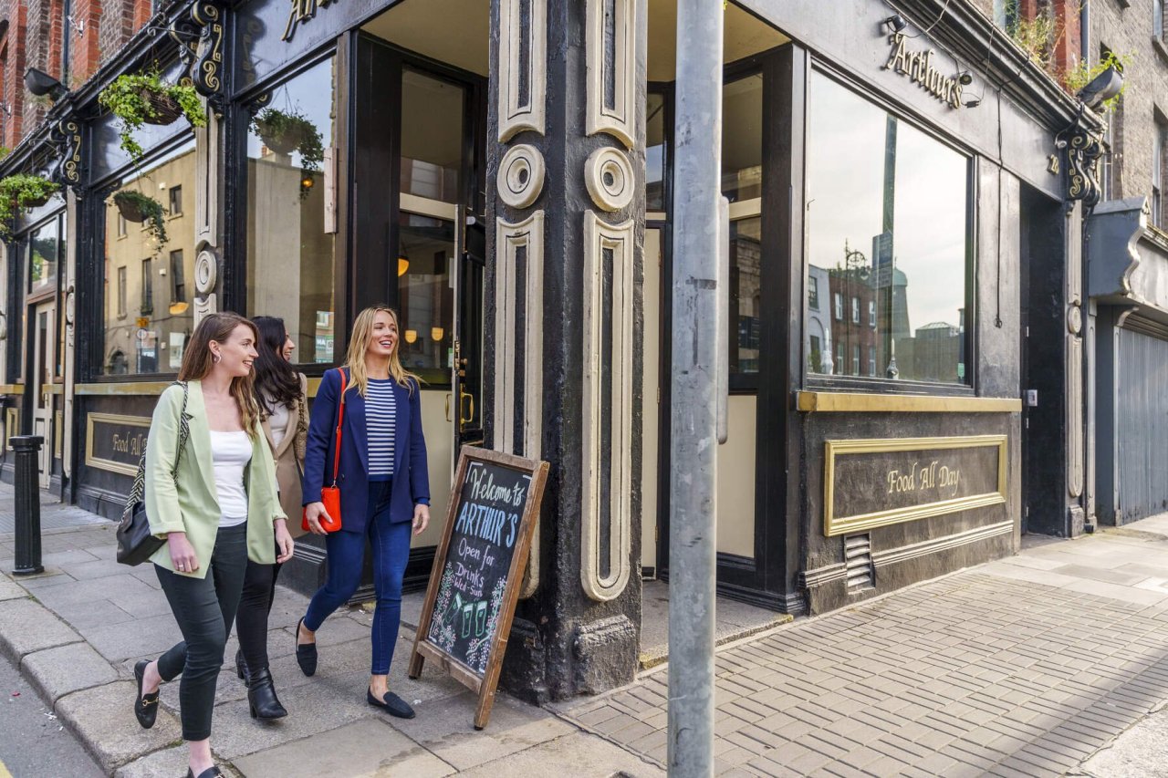 two women walking passed a pub