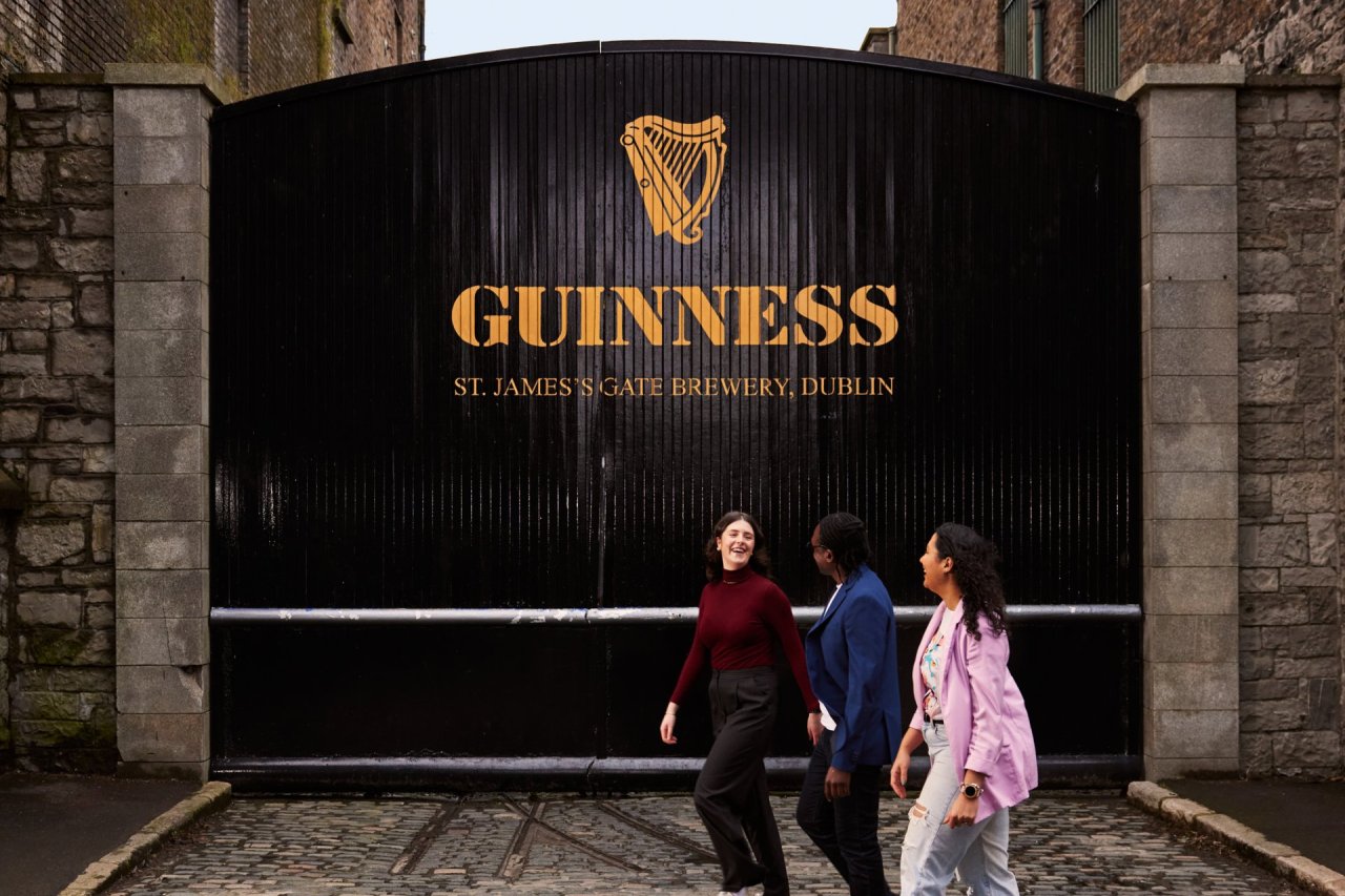 people walking in front of guinness factory