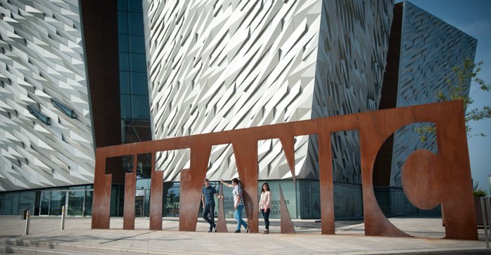 Titanic Visitor Attraction Belfast Group of friends pose for photo outside Titanic Centre Belfast